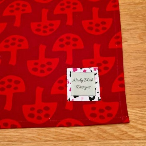 Organic cotton tea towel with Glen Tanar Mushrooms pattern in Very Berry